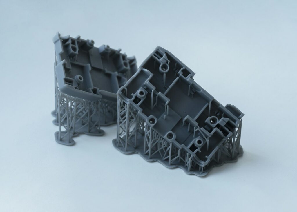 Two grey resin 3D printed concept parts with support structures, the kind of quick build used in a medical device concept feasibility study